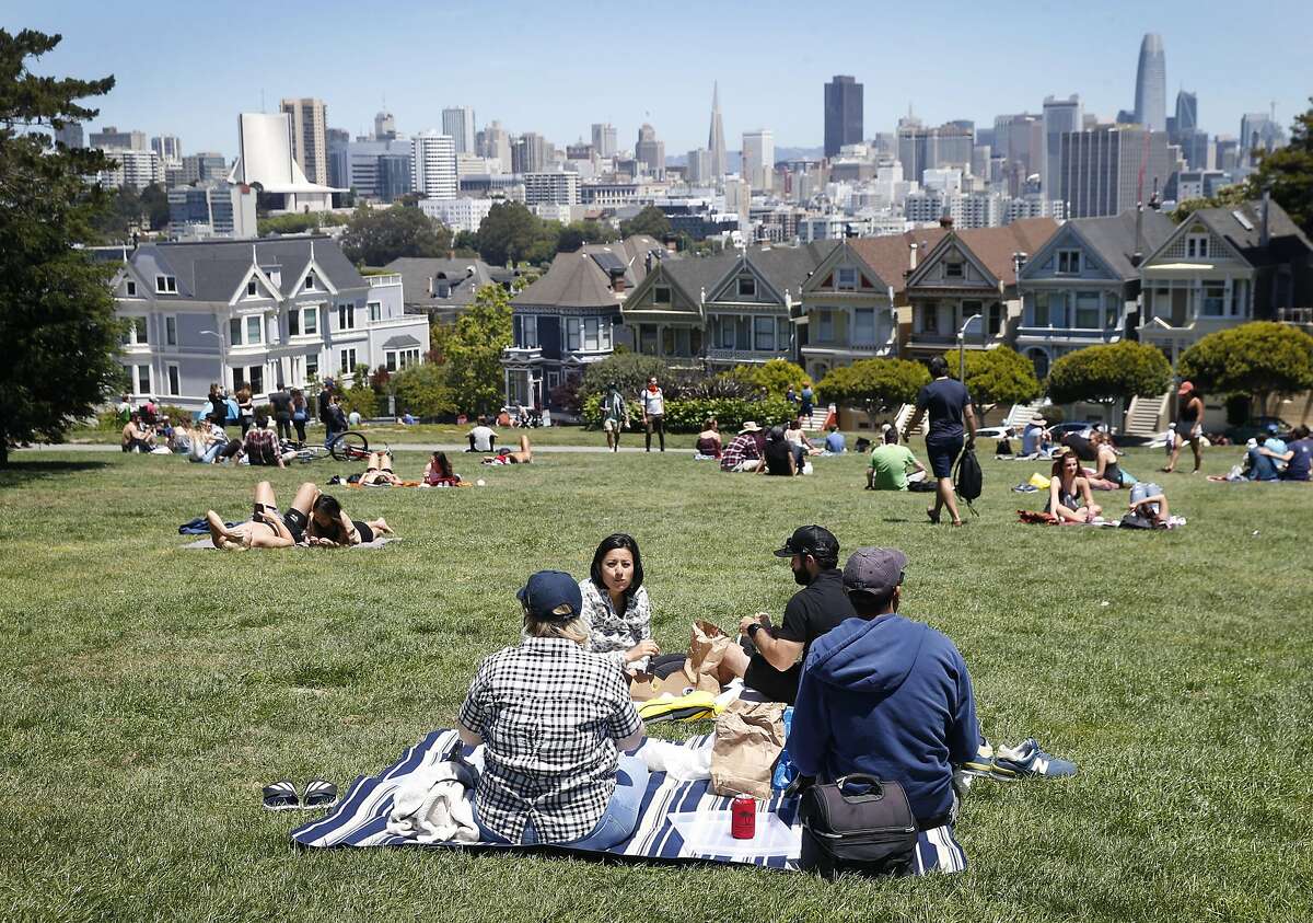 Visitors have plenty of room to throw down a blanket for a picnic or sunbathing at Alamo Square in San Francisco, Calif. on Saturday, May 23, 2020. Officials are concerned that parks and other outdoor locations may be magnets for people who want to enjoy the warm Memorial Day weekend despite shelter in place orders during the coronavirus pandemic.