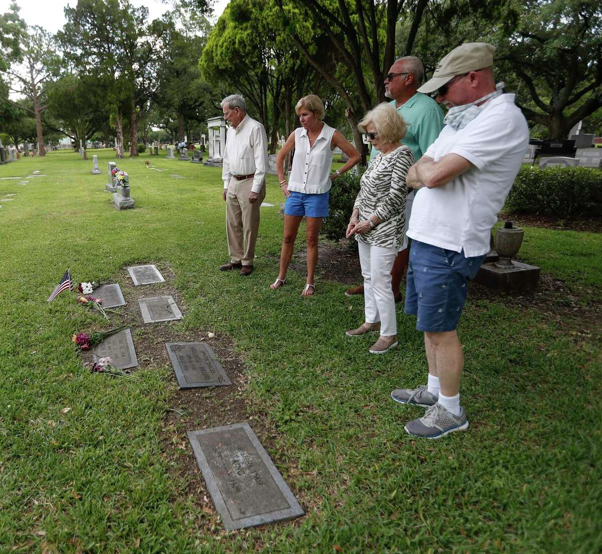 Bill Hosmer, Scotti and Scott Hohensce, Liz Wilson Smith and Jeff Wilson visit the gravesite Saturday of retired Army Col. Ovid “Zero” Wilson at Forest Park Westheimer Cemetery in Houston. As a prisoner of war in the Philippines, “Zero” Wilson survived the Bataan Death March in 1942.