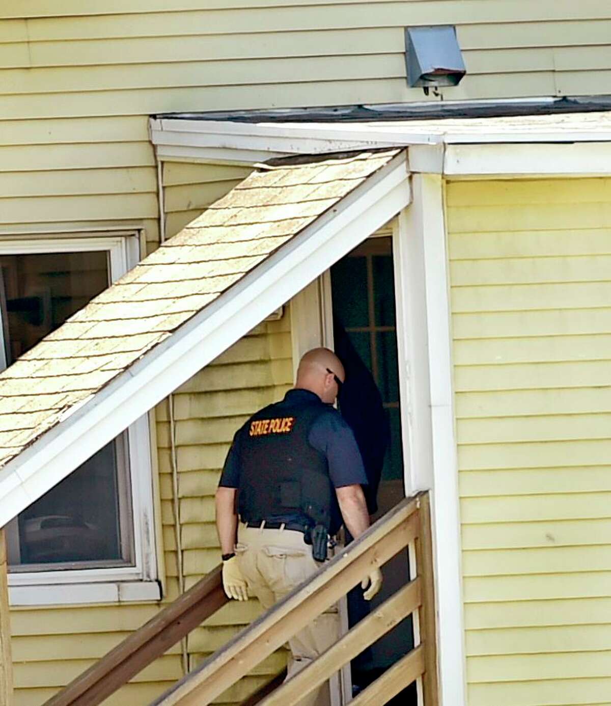 Derby, Connecticut - Sunday, May 24, 2020: Connecticut State Police enters a house on Roosevelt Drive in Derby Sunday afternoon where a male was found deceased in the house during the search for suspected murder Peter Manfredonia, 23, described as armed and dangerous. State Police said Manfredonia is believed to be armed with pistol and long guns. Manfredonia is wanted in a homicide and serious assault in northeastern Connecticut.