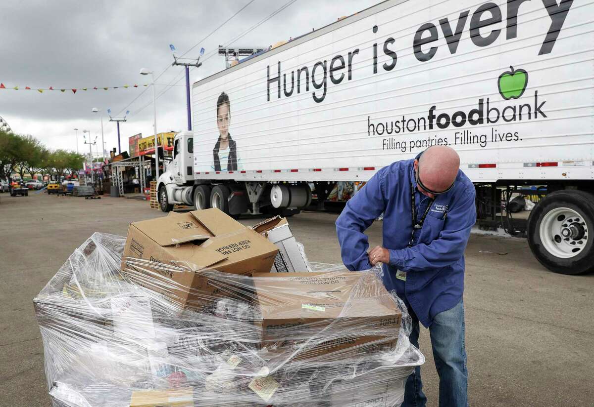 Michael Hawkins, a truck driver with the Houston Food Bank, prepares to load donated food Friday, March 13, 2020, near NRG Stadium in Houston. Vendors from the Houston Livestock Show and Rodeo donated unused food to local charities, including the Houston Food Bank and the Star of Hope, after the rodeo was canceled due to concerns about COVID-19.