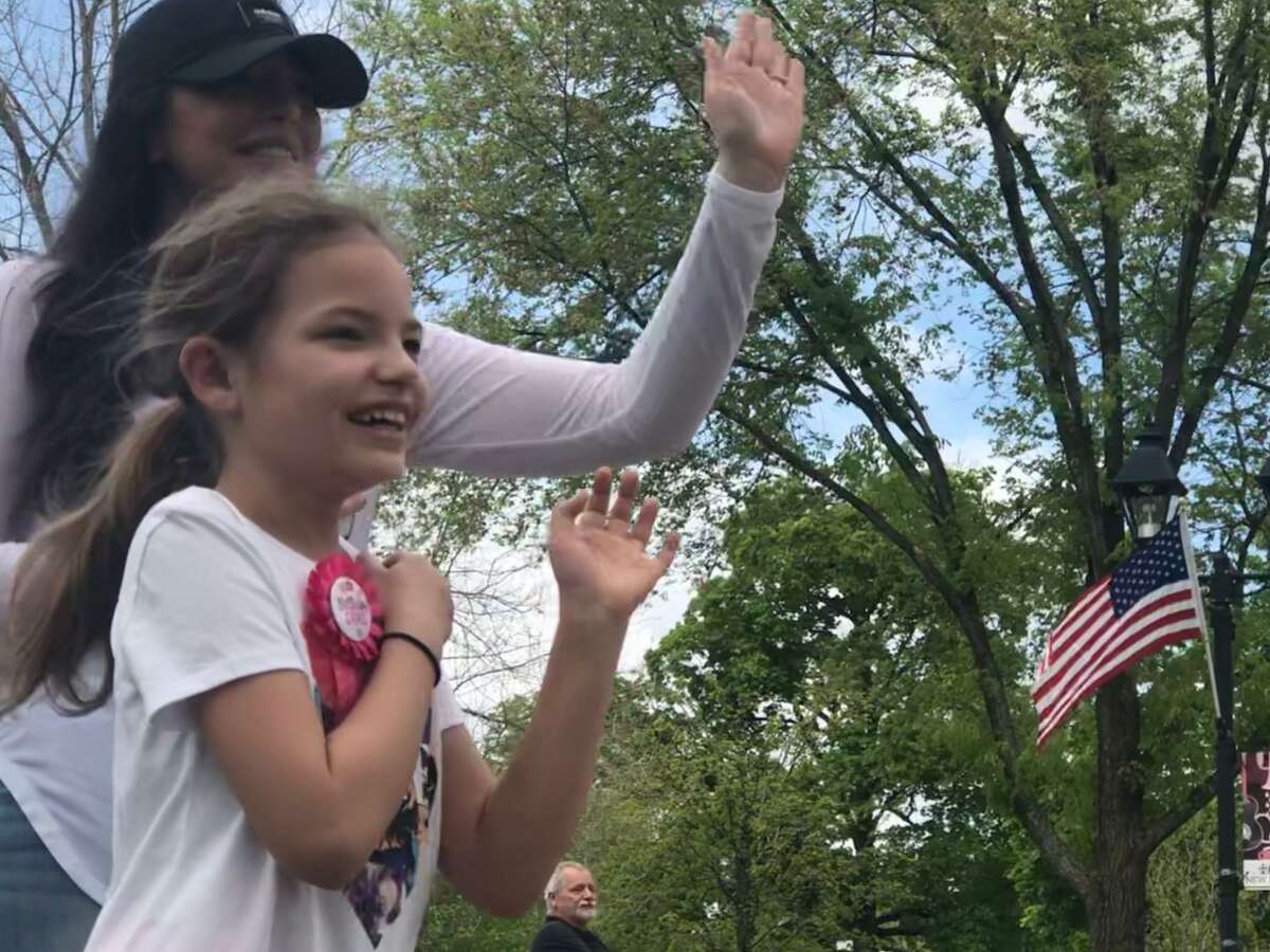 Celebrating a birthday isn't what it used to be these days. Living during a pandemic, when restrictions are in place regarding the amount of people permitted at a gathering and social distancing measures in place, makes it difficult to celebrate a special occasion like a birthday difficult. Lyliana Martinez of New Milford wanted to do something special for her 10th birthday, so she asked family and friends to stop by the Village Green May 17 to say hello and invited people to make a donation to benefit first responders. Her family surprised her with a parade of fire trucks, town trucks and family and friends. Lyliana collected $510 to donate. Above, Lyliana and her mother, Ashley McKenney, wave to the trucks during the parade. May 17, 2020