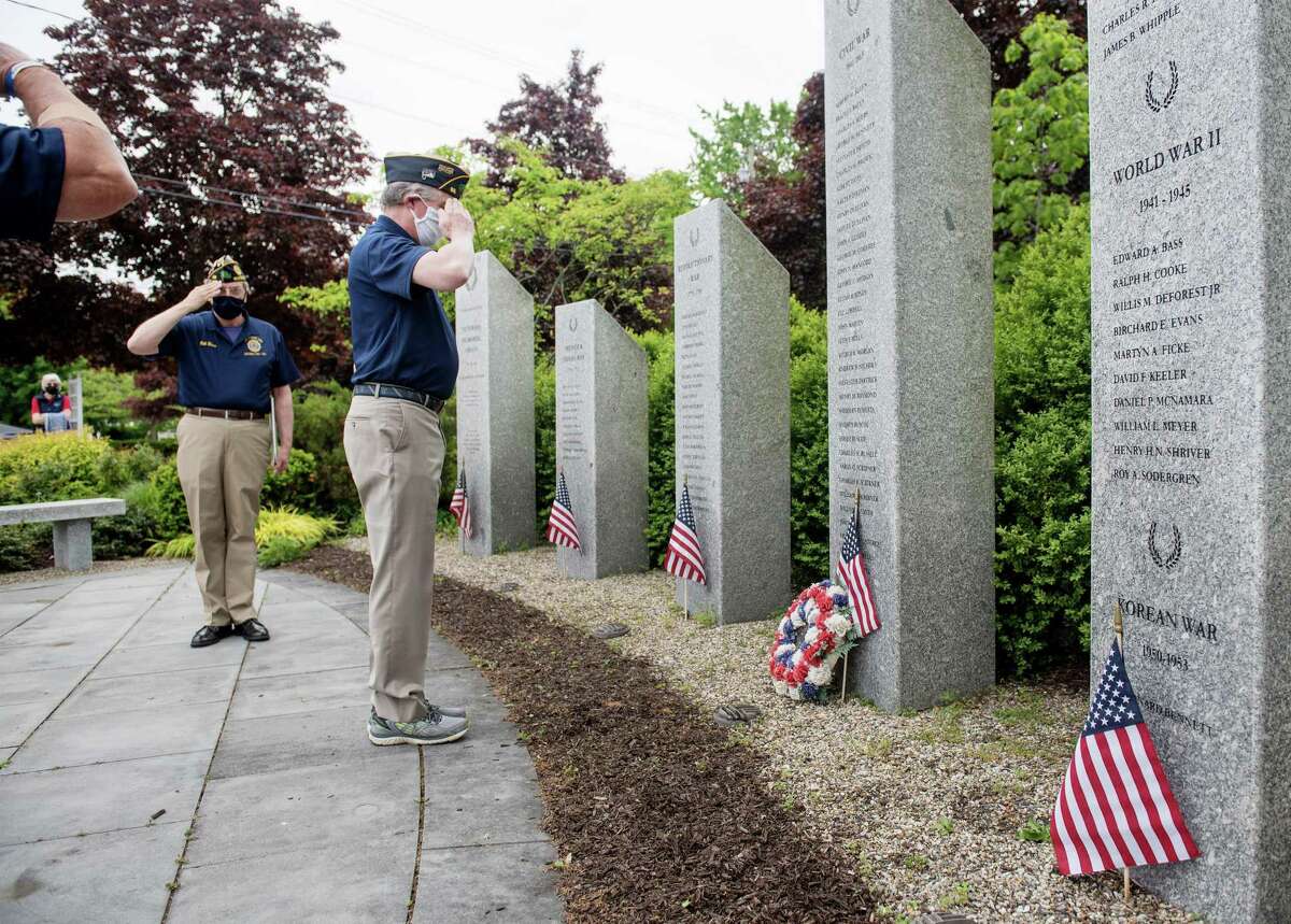American Legion members salute the names of Wilton veterans who gave their lives in service to their country. May 25, 2020.