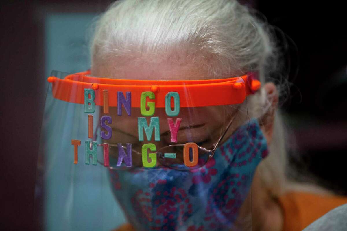Alamo Hills Daytime Bingo employee Linda Pieniazek wears a face shield that reads "Bingo is my thing-o" as she works at the bingo hall. Bingo halls reopened on Friday per state guidelines at 25 percent capacity with social distancing.