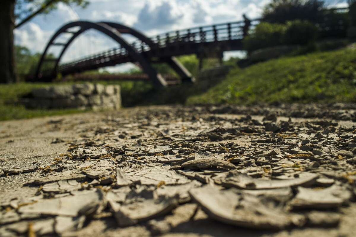 Although floodwaters have receded, dirt and sand remain, covering surfaces near the Tridge in downtown Midland. (Katy Kildee/kkildee@mdn.net)