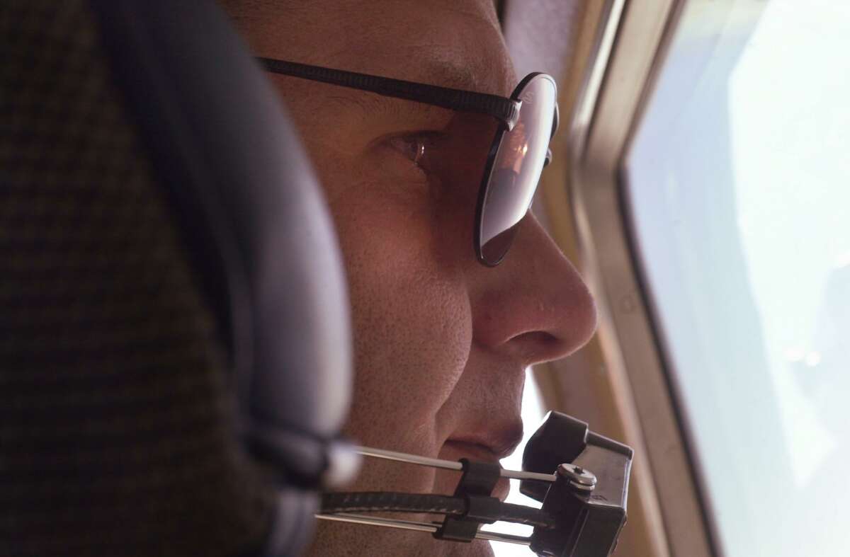 State trooper Gene Baron spots speeding motorists from 2,000 feet while on patrol above I-95 in a single-engine Cessna in August 2001. Baron uses a timing device to identify speeding cars and radios their descriptions to troopers waiting in patrol cars on the roads below.
