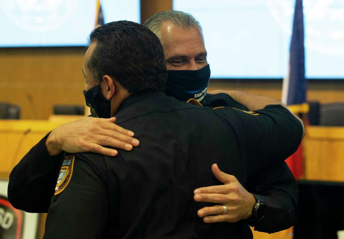 Pedro Lopez and Harris County Chief Deputy Edison Toquica hug each other after Lopez sweared in as HISD's new police chief Tuesday, May 26, 2020, in Houston. Lopez has more than 30 years of experience in law enforcement, including Houston Police Department and Harris County Sheriff's Office, where he and Toquica both worked.