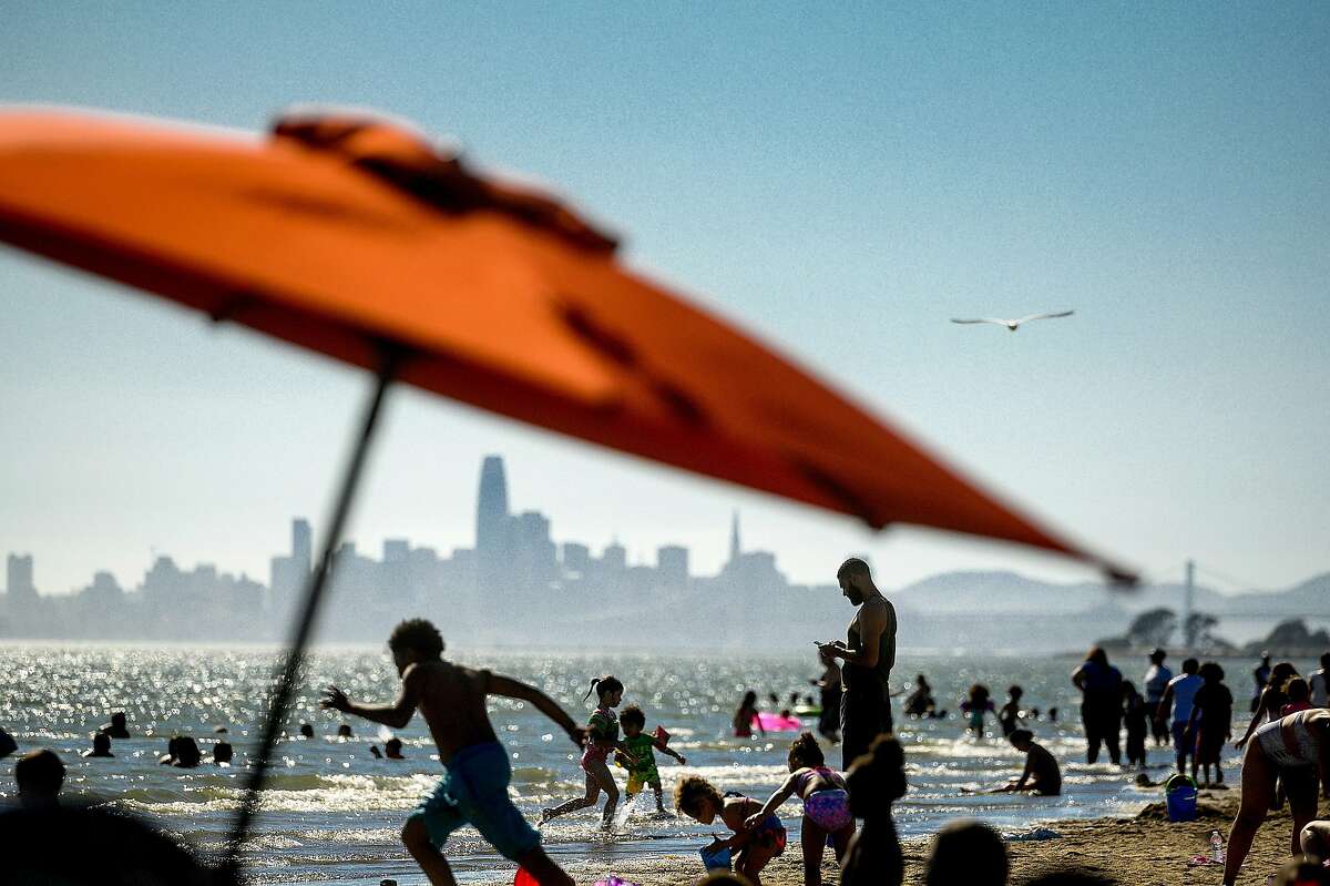 Beachgoers gather at Robert W. Crown Memorial Beach as temperatures throughout the Bay Area soar on Tuesday, May 26, 2020, in Alameda, Calif.