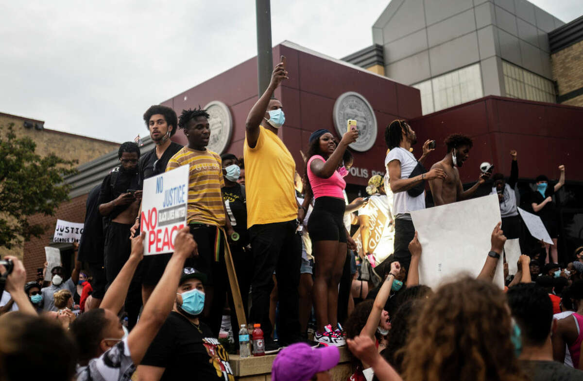 Protesters demonstrate against the death of George Floyd outside the 3rd Precinct Police Precinct on May 26, 2020 in Minneapolis, Minnesota. Four Minneapolis police officers have been fired after a video taken by a bystander was posted on social media showing Floyd's neck being pinned to the ground by an officer as he repeatedly said, "I canât breathe". Floyd was later pronounced dead while in police custody after being transported to Hennepin County Medical Center. (Photo by Stephen Maturen/Getty Images)