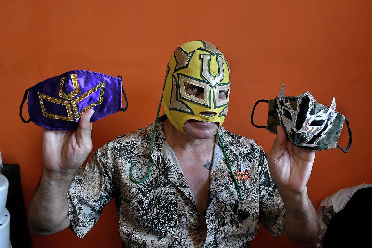 Local wrestler El Universitario displays some of his homemade facemasks Thursday, May 14.