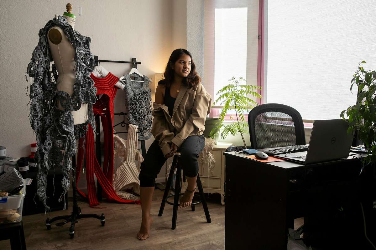 Aishwarya Gajare knits at her home on Tuesday, May 26, 2020, in San Francisco, Calif. Gajare is a knitwear design student at the Academy of Art University. The school’s runway show was rescheduled, amid the coronavirus pandemic.