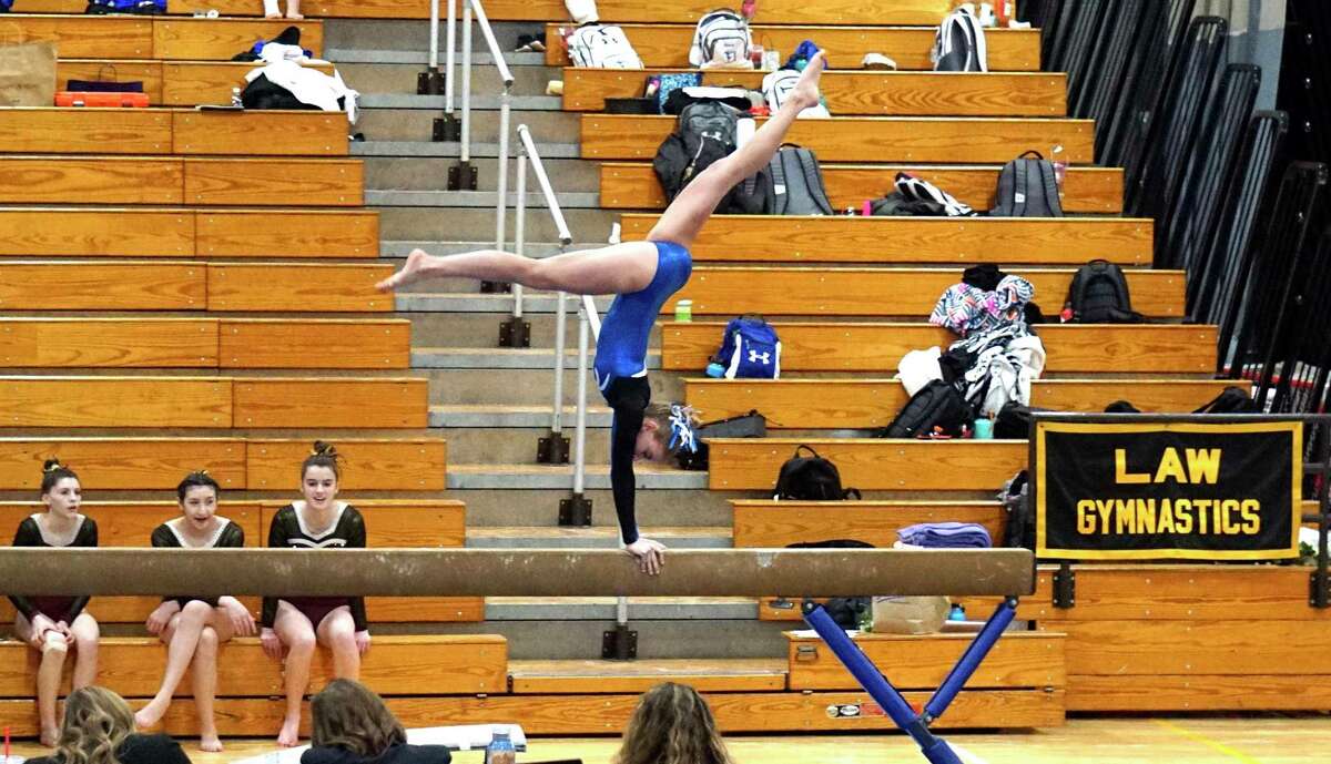 Darien's Lucy Collins competes on the balance beam during the CIAC Class M gymnastics championship meet at Johnathan Law in Milford on Saturday, Feb. 29, 2020.