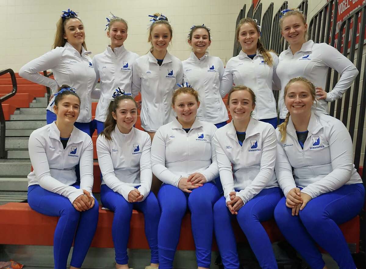 The 2020 Darien gymnastics team, from left, front row, Maggie Russell, Olivia Perkins, Alex Decsi, Mia MacDonald, and Sommer Schmidt; back row, Lauren Grandon, Lucy Collins, Abby Kissko, Megan Cutler, Lana Schmidt, and Kerry McDermott.