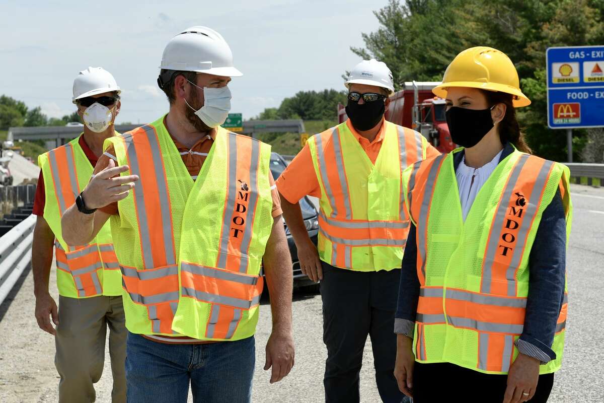 Gov. Gretchen Whitmer, right, speaks with MDOT workers about the work being done to the U.S. 10 bridge in Sanford Wednesday, May 27, 2020. (Photo provided/MDOT)