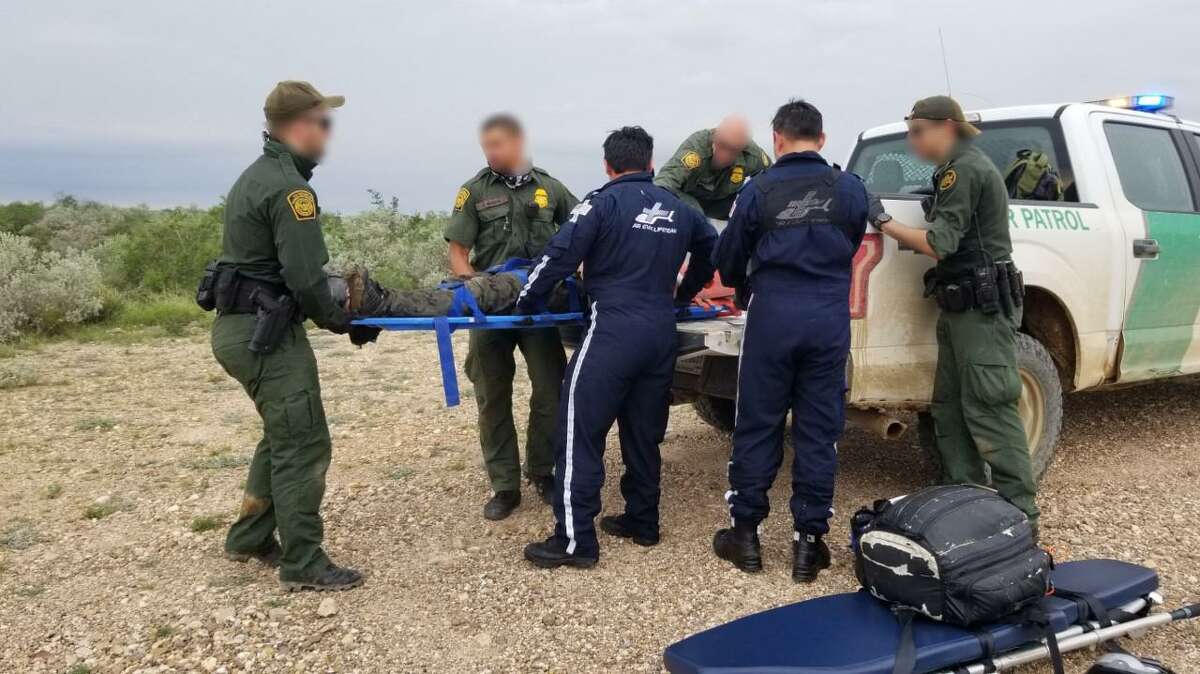 U.S. Border Patrol render medical attention to a woman who was lost at a ranch along with her two children. Authorities said the family was in the country in the illegally.
