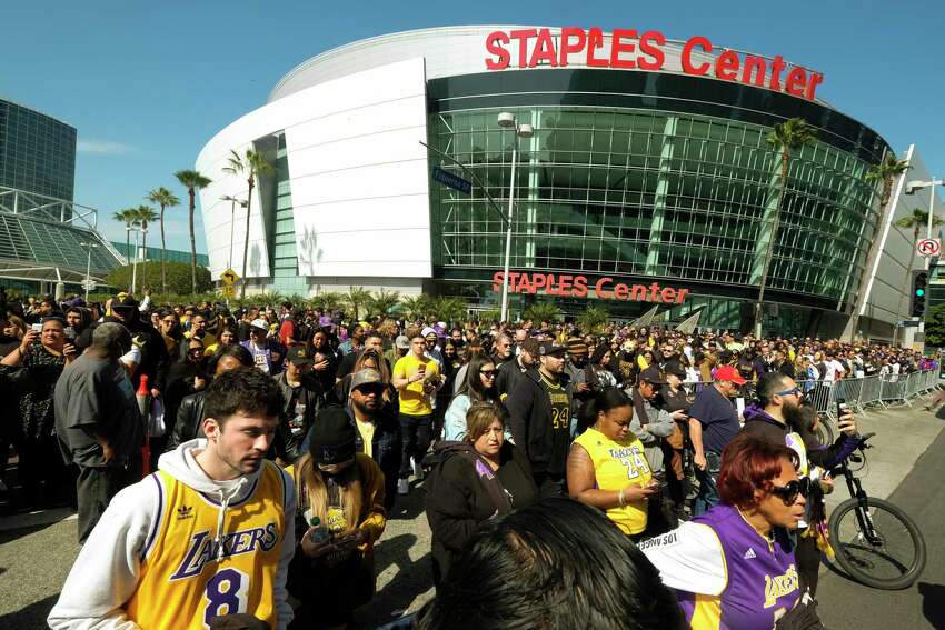 FILE - In this Feb. 24 2020, file photo, fans leave the Staples Center after a public memorial for former Los Angeles Lakers star Kobe Bryant and his daughter, Gianna, in Los Angeles. Staple Center is one of the possible locations the NHL has zeroed in on to host playoff games if it can return amid the coronavirus pandemic. The league will ultimately decide on two or three locations for games, with government regulations, testing and COVID-19 frequency among the factors for the decision that should be coming within the next three to four weeks. (AP Photo/Ringo H.W. Chiu, File)