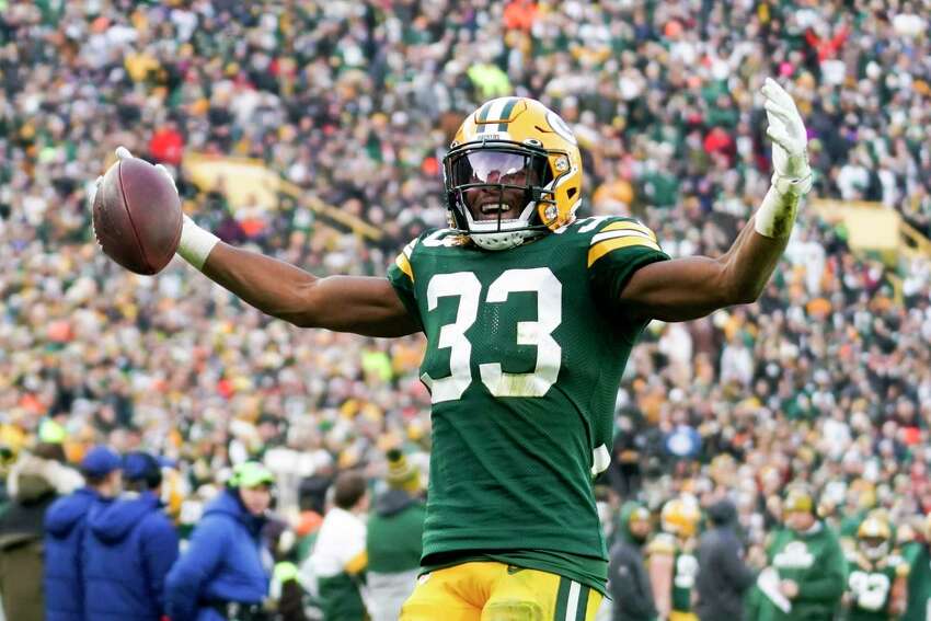 FILE - In this Dec. 8, 2019, file photo, Green Bay Packers' Aaron Jones reacts after his first down run during the second half of an NFL football game against the Washington Redskins, in Green Bay, Wis. Jones says he wants to remain in Green Bay for his entire career and that he wona€™t let speculation about his future distract him as he enters the final season of his contract. (AP Photo/Morry Gash, File)
