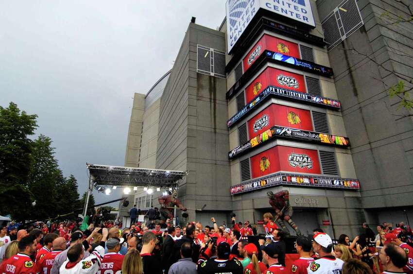 FILE - In this June 8, 2015, file photo, hockey fans gather around former Chicago Blackhawk Jeremy Roenick outside the United Center before Game 3 of the NHL hockey Stanley Cup Final against the Tampa Bay Lightning, in Chicago. The United Center is one of the possible locations the NHL has zeroed in on to host playoff games if it can return amid the coronavirus pandemic. The league will ultimately decide on two or three locations for games, with government regulations, testing and COVID-19 frequency among the factors for the decision that should be coming within the next three to four weeks. (John Starks/Daily Herald via AP, File)