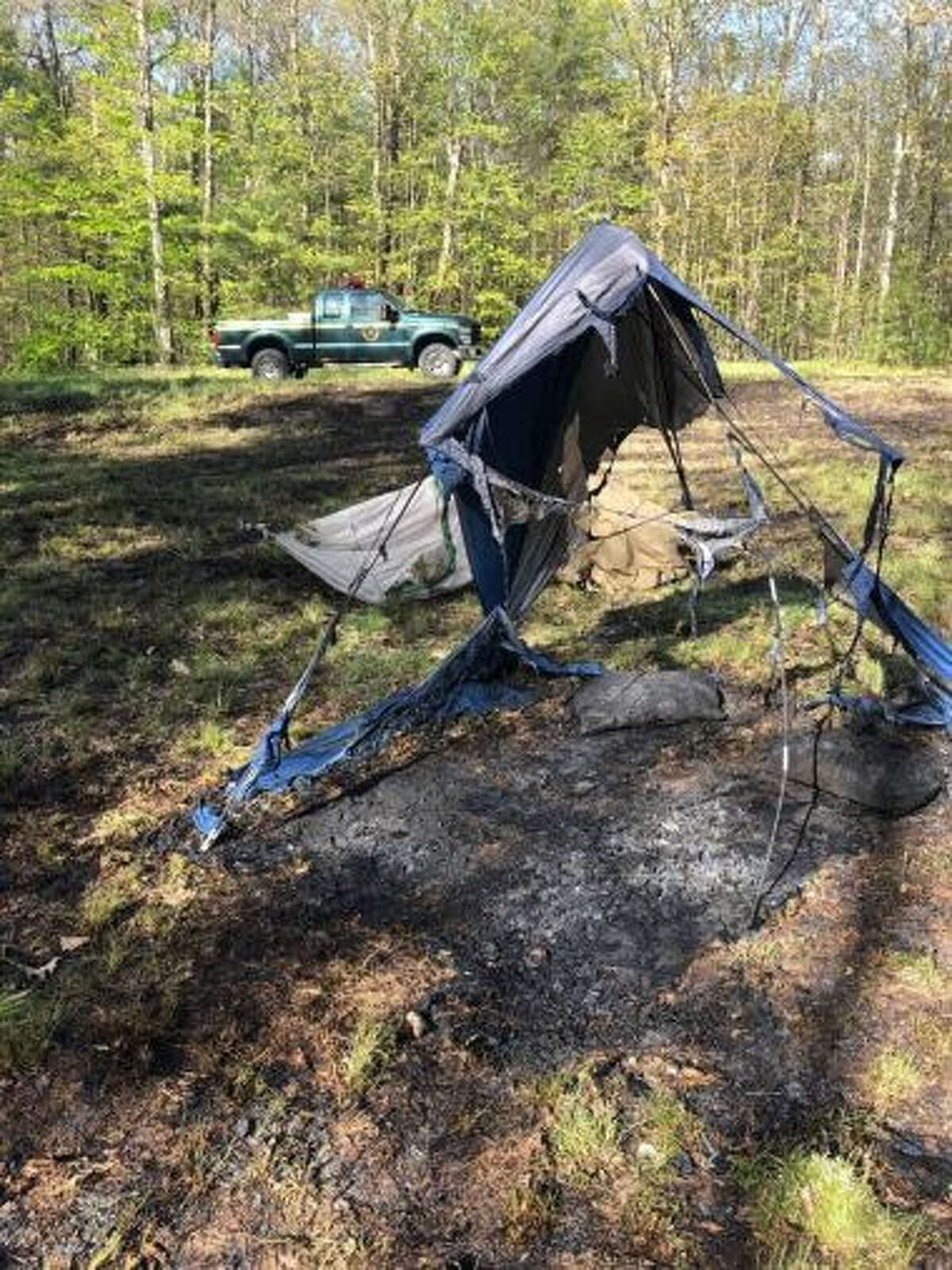 The state Department of Environmental Conservation says four campers who left a campfire unattended at a state campground in Austerlitz on Monday lost all of their belongings after the flames spread to nearby brush and ended up burning 1.8 acres of forest.