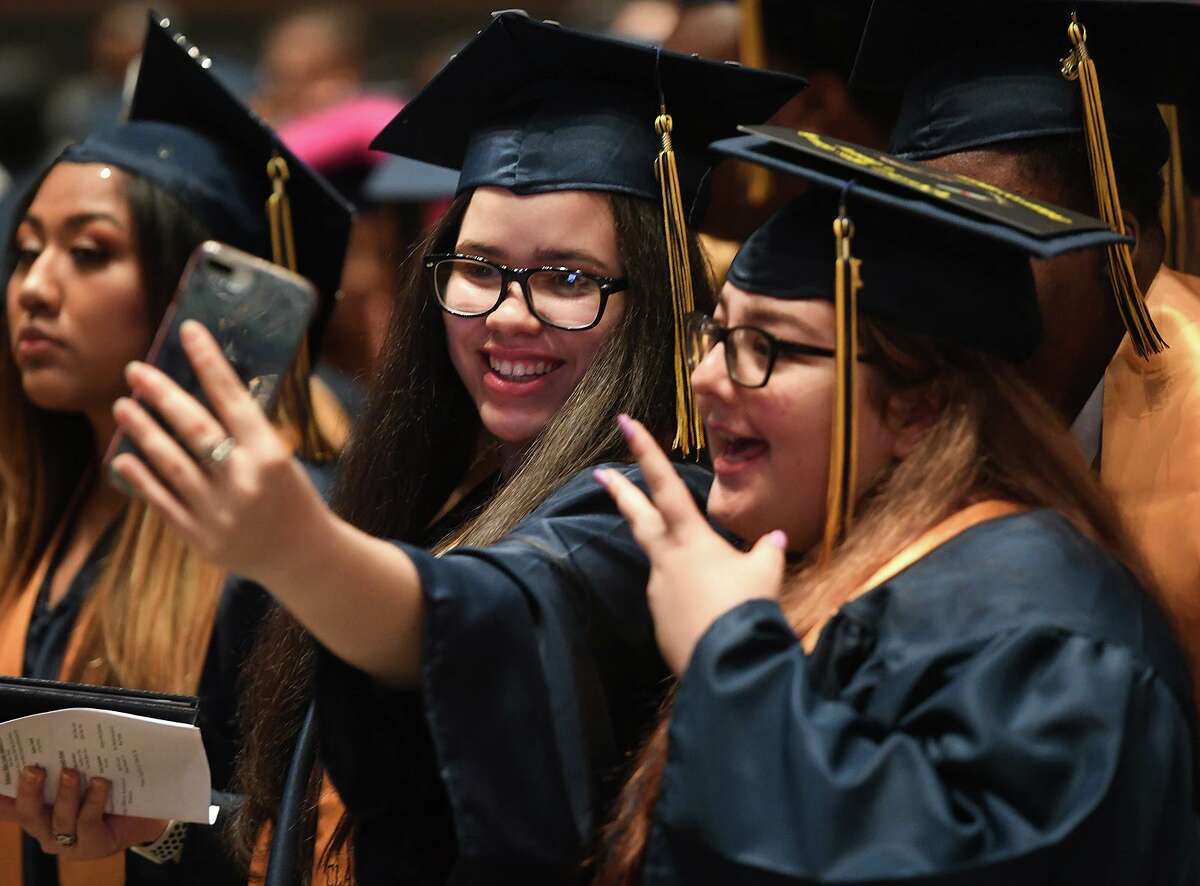 Salutatorian Glorimar Falcon, left, and valedictorian Amanda Tecci pose for a selfie during the Bridgeport Military Academy Commencement at Harding High School in Bridgeport on June 18, 2019. This year’s graduation will take place June 18 from 9 to 11 a.m.