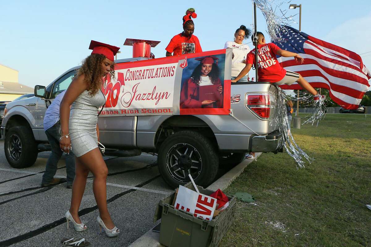 Judson senior Jazzlyn Graves, 18, left, changes shoes in the Maranatha Bible Church parking lot in preparation for Judson High School’s Sunset Car Parade honoring the Class of 2020. The celebration, held Friday, May 22, left the church parking lot and made its way to the high school.