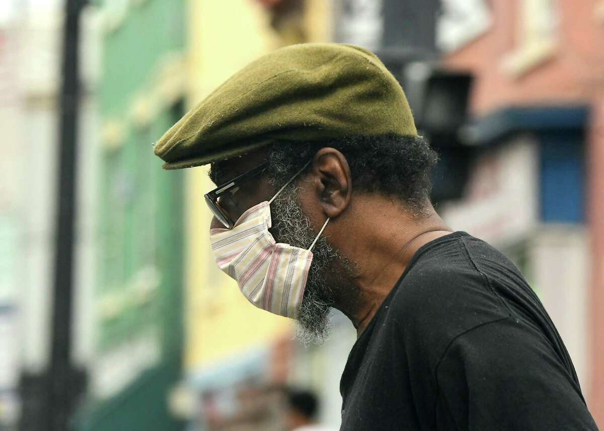 A pedestrian is seen wearing a mask on Thursday, May 28, 2020 in Albany, N.Y. (Lori Van Buren/Times Union)