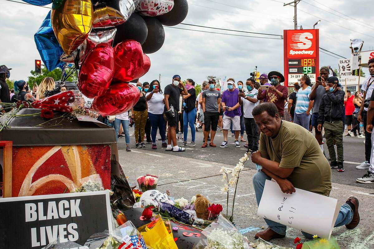 A man prays in front of a makeshift memorial in honor of George Floyd who died in custody on May 26, 2020 in Minneapolis, Minnesota. - A video of a handcuffed black man dying while a Minneapolis officer knelt on his neck for more than five minutes sparked a fresh furor in the US over police treatment of African Americans Tuesday. Minneapolis Mayor Jacob Frey fired four police officers following the death in custody of George Floyd on Monday as the suspect was pressed shirtless onto a Minneapolis street, one officer's knee on his neck. (Photo by Kerem Yucel / AFP) (Photo by KEREM YUCEL/AFP via Getty Images)