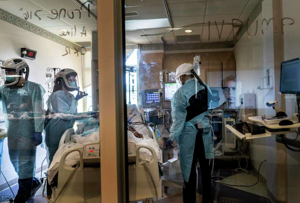 Nurses and respiratory specialists treat coronavirus patients at El Centro Regional Medical Center in California, with a doctor phoning in.