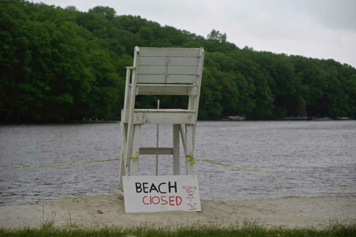 A sign at Sherman Town Beach on Candlewood Lake alerts residents the beach was closed for Memorial Day.