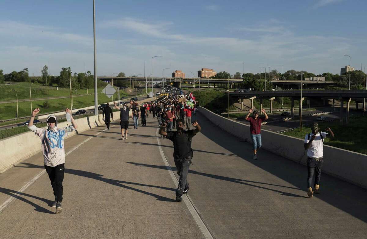 MINNEAPOLIS, MN - MAY 28: Protesters march down a highway off-ramp on May 28, 2020 on their way to Minneapolis, Minnesota. Police and protesters continued to clash for a third night after George Floyd was killed in police custody on Monday. (Photo by Stephen Maturen/Getty Images)