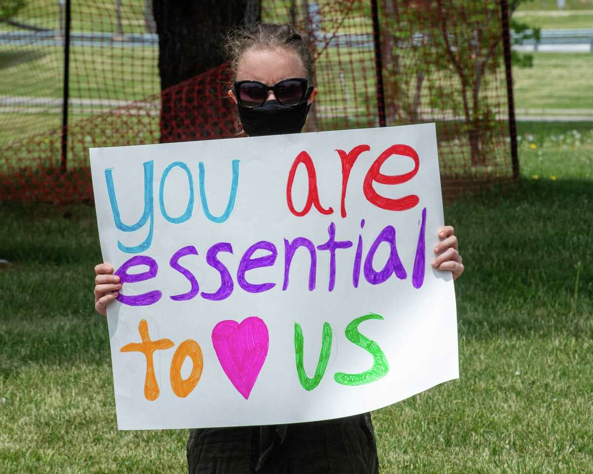 Michelle Polacinski, of ADAPT Capital Region, holds a sign during a vigil at Shaker Place Rehabilitation and Nursing in Colonie NY on Saturday, May 23, 2020 calling on New York state to support nursing home workers, transfer residents who so choose to safer settings and step up state regulations of nursing homes (Jim Franco/Special to the Times Union.)