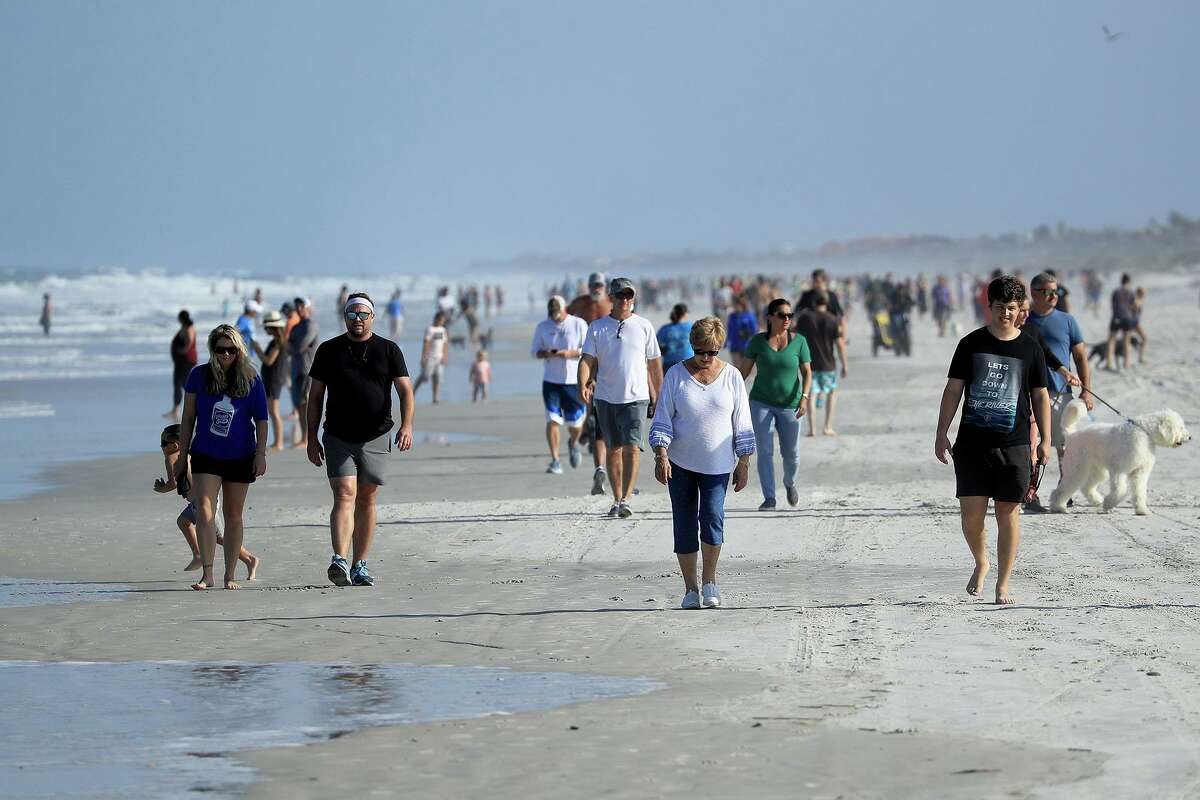 People are seen at the beach on April 17, 2020, in Jacksonville Beach, Fla., after social distancing restrictions were partially eased. (Sam Greenwood/Getty Images/TNS)