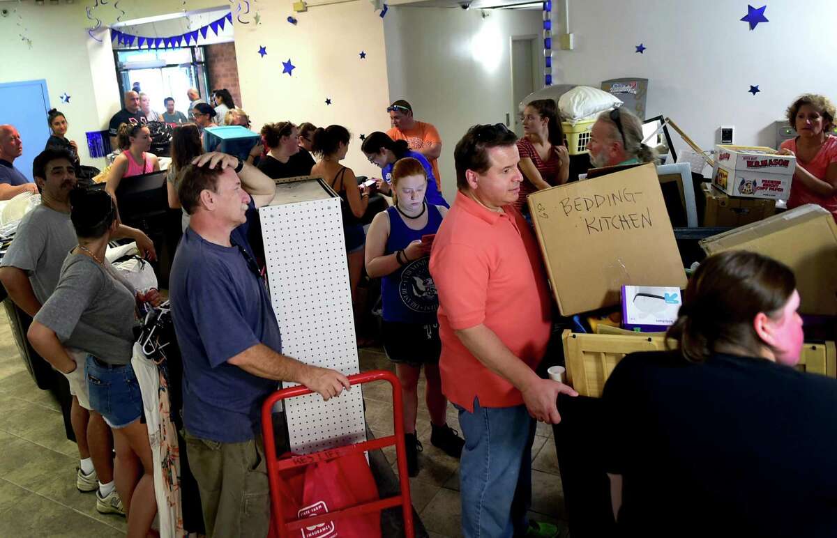 (Peter Hvizdak - New Haven Register) Fathers Frank Duffy of Bridgeport, left, and Nick LoPreiato (CQ) of Newington, right, wait in line for elevators as they help their daughters, seniors, move their belongings into the Southern Connecticut State University North Campus Mid-Rise residency hall during move-in-day at the S.C.S.U. in New Haven. Sunday, August 28, 2016. See the photo gallery at photos.newhavenregister.com.