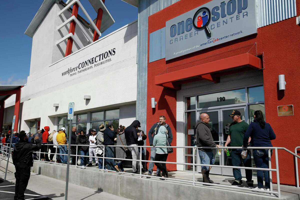 People wait in line for help with unemployment benefits at the One-Stop Career Center in Las Vegas, March 17. With unemployment estimated at 20 percent, similar to the Great Depression, the WPA is a better model of assistance.