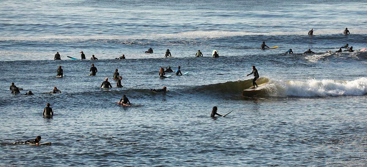Surfers take advantage of the low tide swell at Malibu Surfrider Beach next to the Malibu pier as Los Angeles County beaches reopen to the public on Wednesday, May 13, 2020, amid the coronavirus pandemic. (Al Seib/Los Angeles Times/TNS)