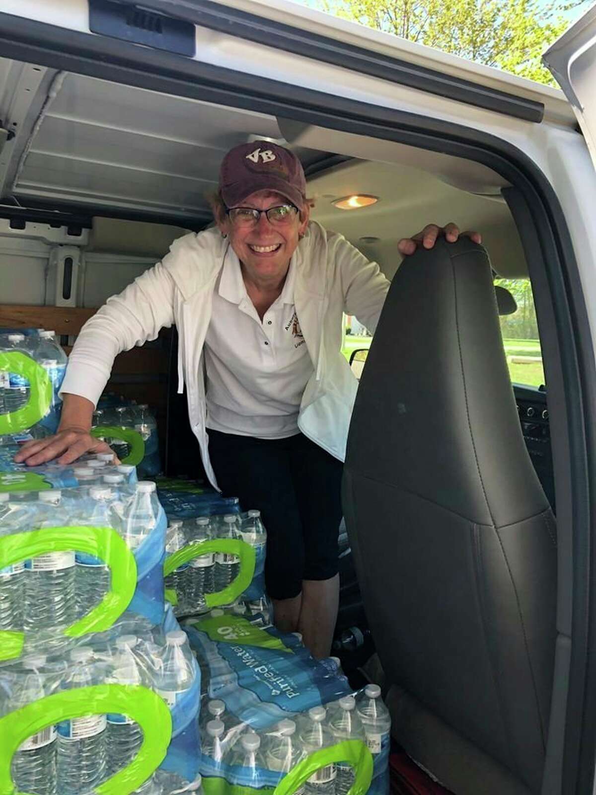 Lion Debra VanTol is shown in a van at the Freeland Sports Zone with donated water that is about to be distributed to flood victims in Tittabawassee and Saginaw Townships. (Photo Provided)
