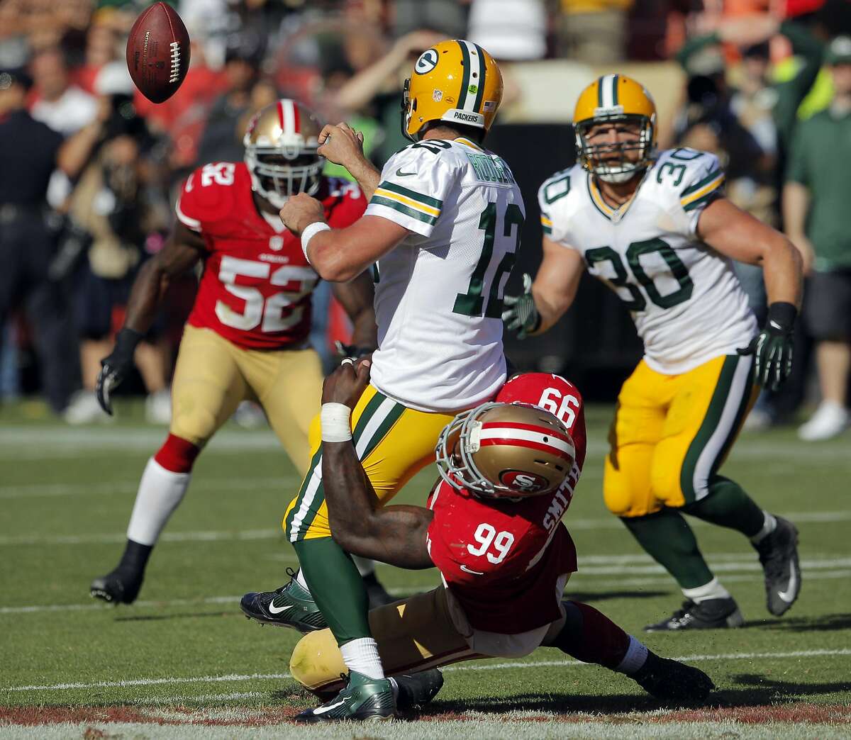 Aldon Smith pressures Aaron Rogers who tries to throw a shuffle pass in the final seconds of the fourth quarter. The San Francisco 49ers played the Green Bay Packers at Candelstick Park in San Francisco, Calif, on Sunday, September 8, 2013.
