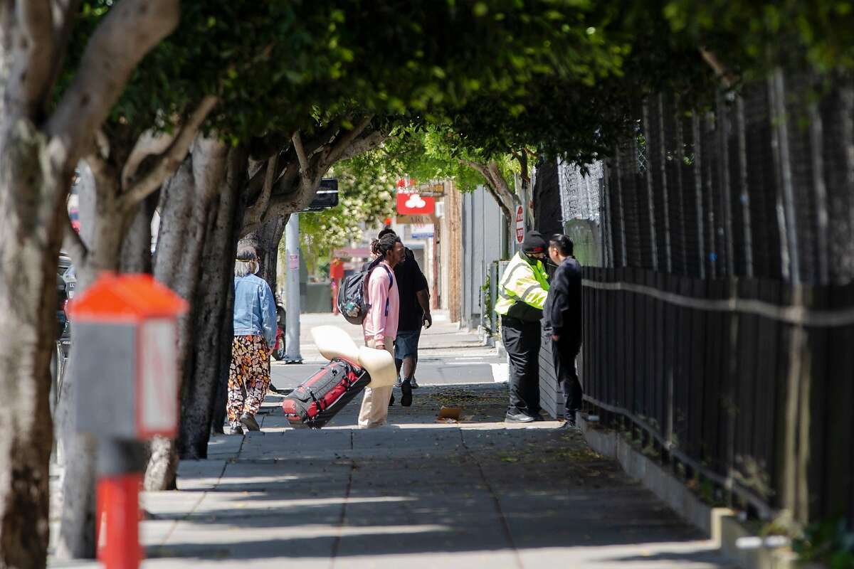 An unhoused person waits to enter San Francisco's second Safe Sleeping Village is at the corner of Haight Street and Stanyan Street on Friday, May 29, 2020.
