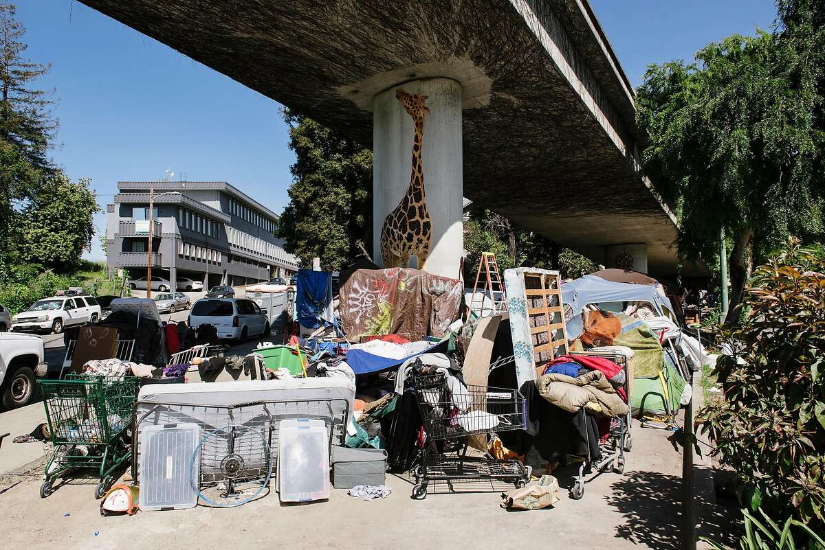 Tents and belongings at a homeless encampment underneath Interstate 580 in Oakland in April.