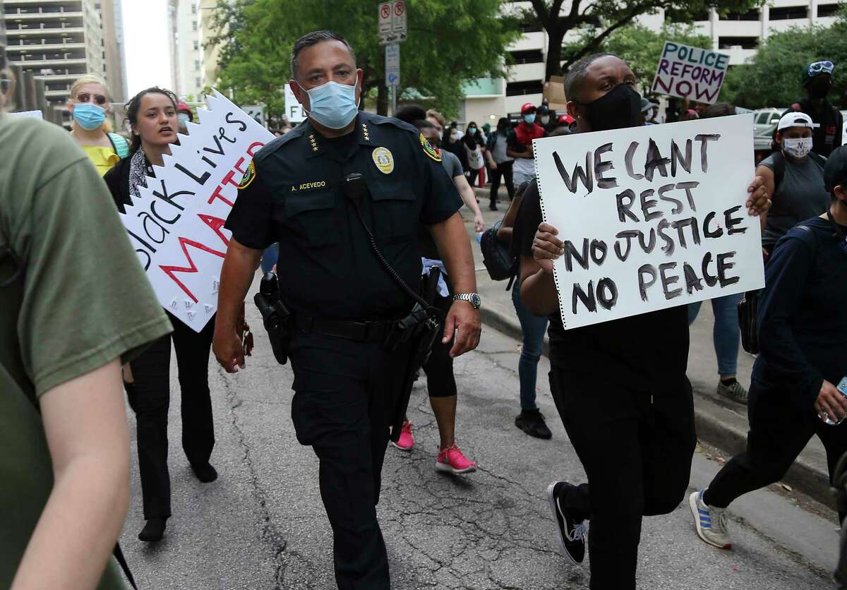 Houston Police Chief Art Acevedo walks with some protesters down Walker Street in downtown Houston on Friday, May 29, 2020.