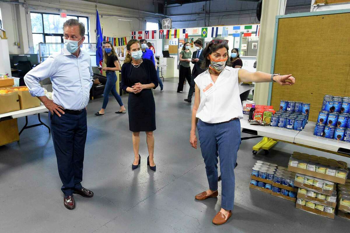At right, Executive Director Catalina Samper-Horak shows Connecticut Governor Ned Lamont and Lt. Governor Susan Bysiewicz the collected donations gathered from the community as they visited Building One Community in Stamford, Connecticut on May 29, 2020. On March 15, 2021, Samper-Horak was announced as the interim CEO of the nonprofit 4-CT.