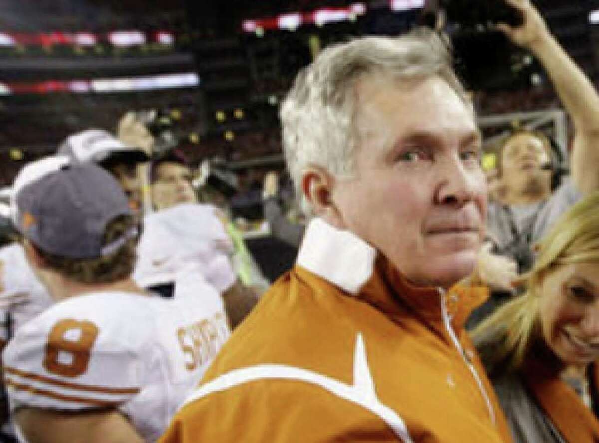 Coach Mack Brown, celebrating with his wife and players after Texas won the Big 12 championship game, is under contract through 2016.