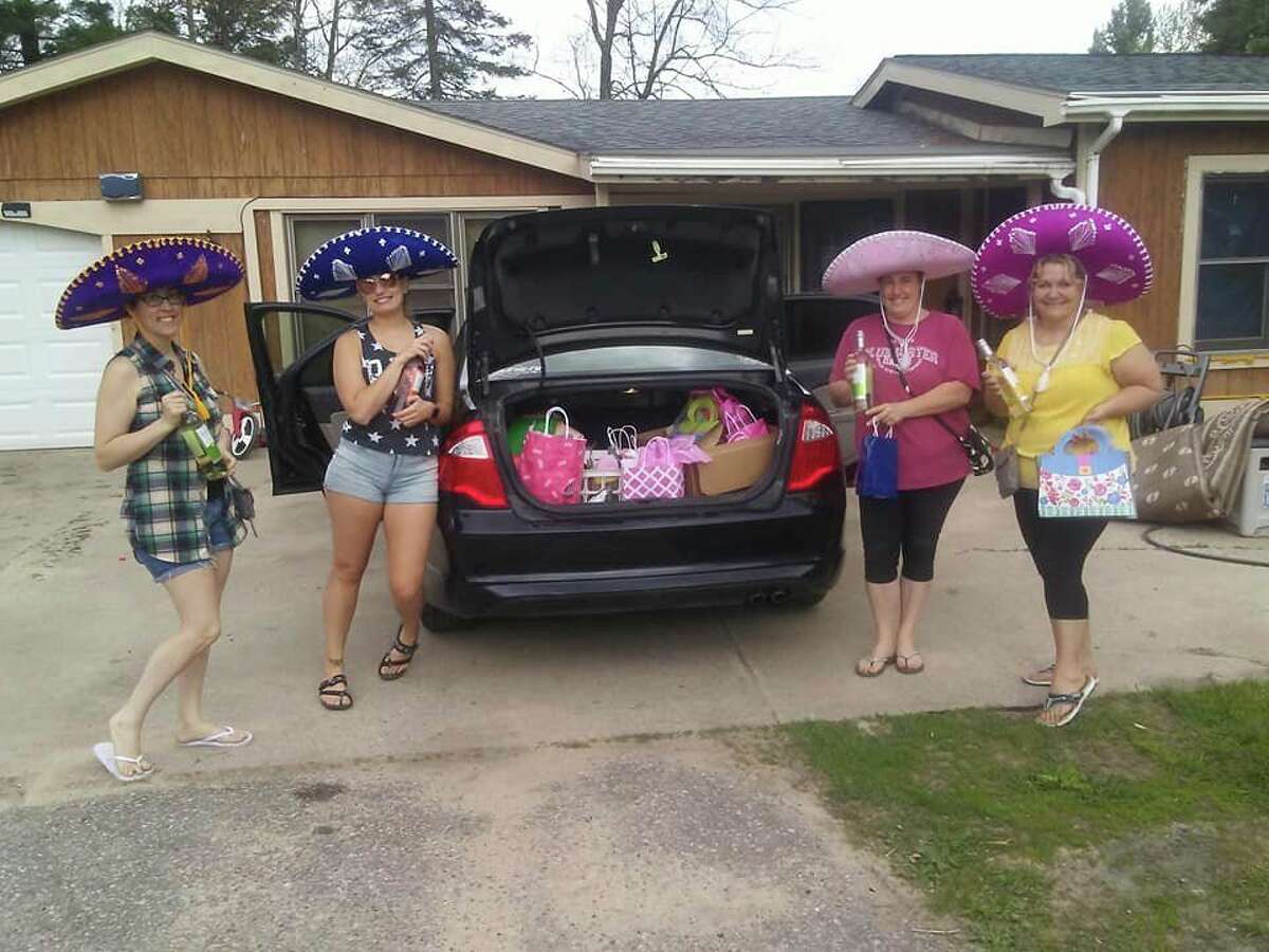 A group of "wine fairies" with the Sisterhood of the Traveling Wine - Mid Michigan prepare to make a delivery. (Photo provided/Facebook)