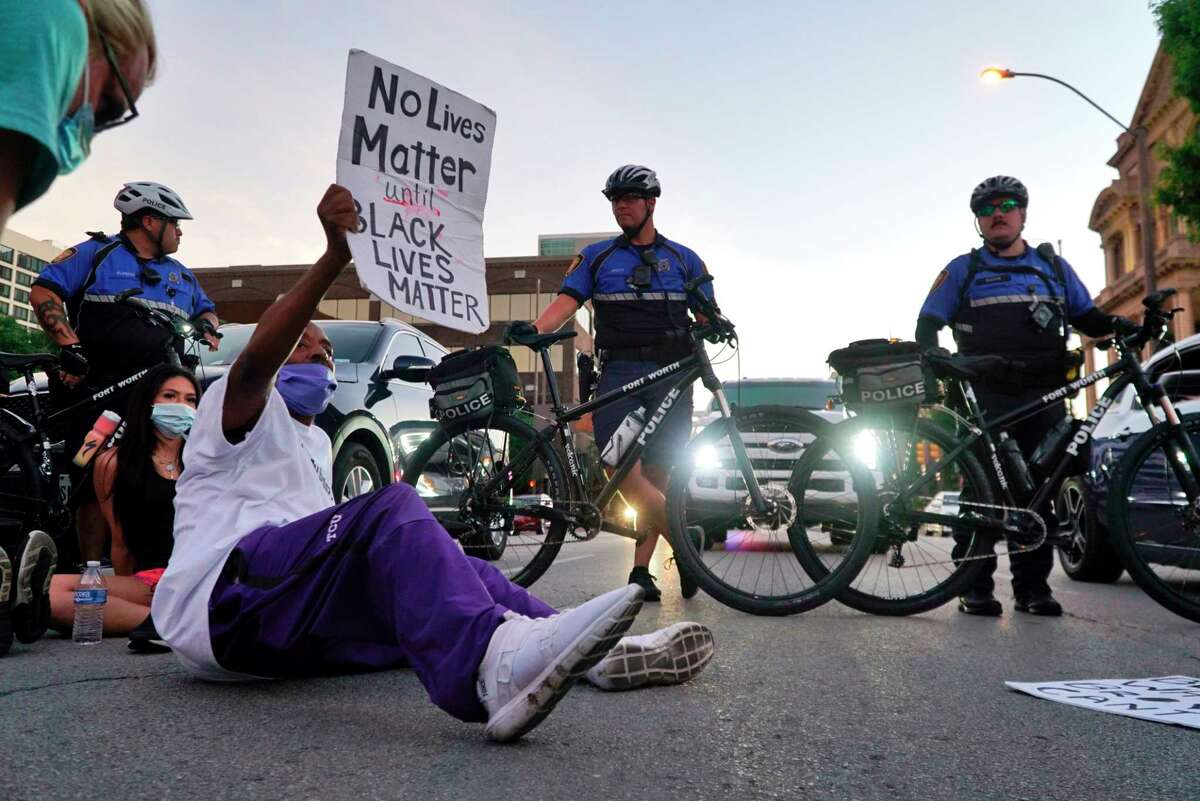 Donnell Ballard blocks traffic during a march in downtown Fort Worth, Texas on Friday, May 29, 2020. The protest was to show solidarity in the midst of the latest killing of George Floyd, an African American man by police in Minnesota. (Lawrence Jenkins/The Dallas Morning News via AP)