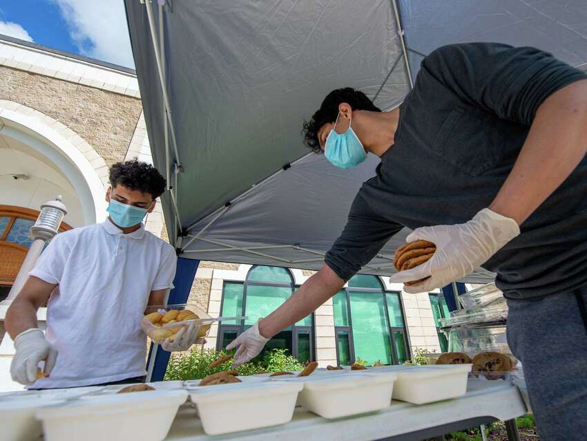 Zaid Shehzad and Mohammed Ahmed prepare food at the Al-Hidaya Center in Latham NY for delivery to community service sites during the Fifth National Muslim Soup Kitchen Day on Saturday, May 30, 2020. (Jim Franco/Special to the Times Union.)