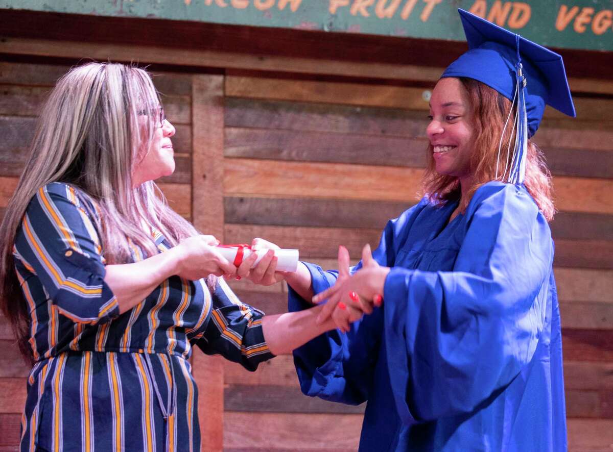 Aerial Wilson receives her diploma during a graduation ceremony at Dosey Doe, Friday, May 29, 2020, in The Woodlands. The Kaiser family, which owns several McDonald’s restaurants in Montgomery County, held the event for 18 employees whose high schools are not holding graduation ceremonies.