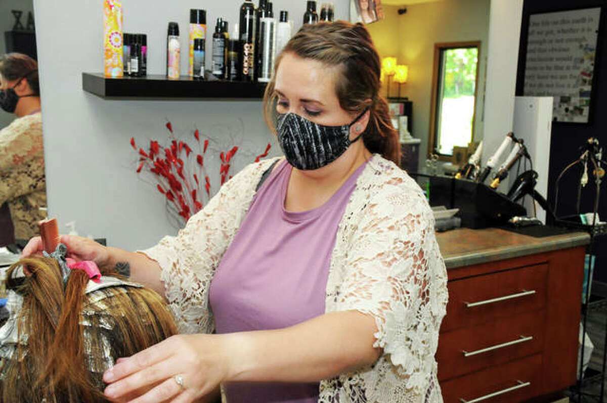 Stylist Julie Valstad works with a client Saturday at My Time Day Spa, 13 Rosa Ave., in Godfrey. The spa is included in the village of Godfrey’s recently launched Small Business Community Gift Card program, in which the village subsidizes half of the face value of online-purchased gift cards to be spent at merchants in the Godfrey business district.