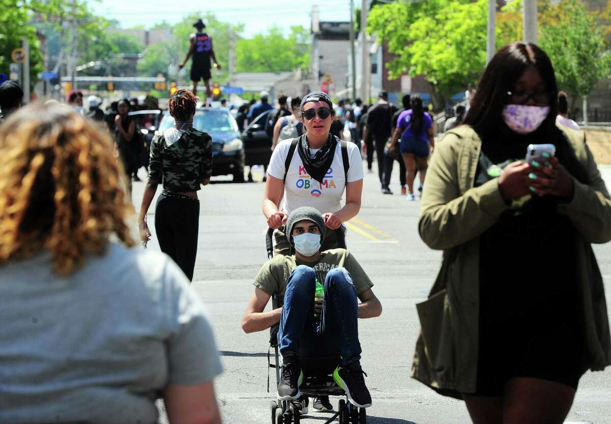 Hundreds of protestors make their way on foot around Bridgeport, Conn., on Saturday May 30, 2020. Over 100 people started protesting at Bridgeport Police headquarters before heading to McLevy Green in downtown Bridgeport and then over to the East Side. The protest was one of dozens all over the country after the death of George Floyd in Minneapolis.