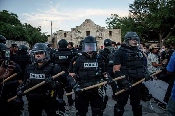 San Antonio police officers stand at the Alamo last month as people protest  the death of George Floyd. But there have also been unwelcome armed “defenders” of the Alamo. We can’t let such fringe groups hijack a full retelling of the Alamo story.