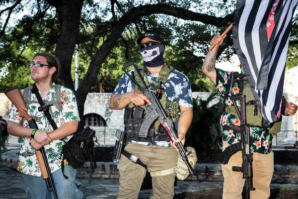 Military-style groups brandished firearms to protect the Cenotaph in front of the Alamo.