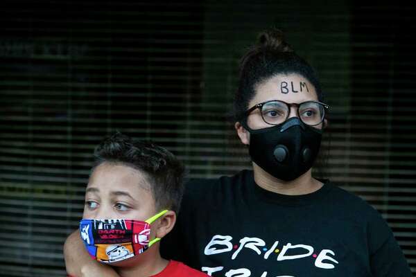 Daeja Lewis, 24, and her brother Jonathan Lewis, 9, pose together during a protest to honor George Floyd.